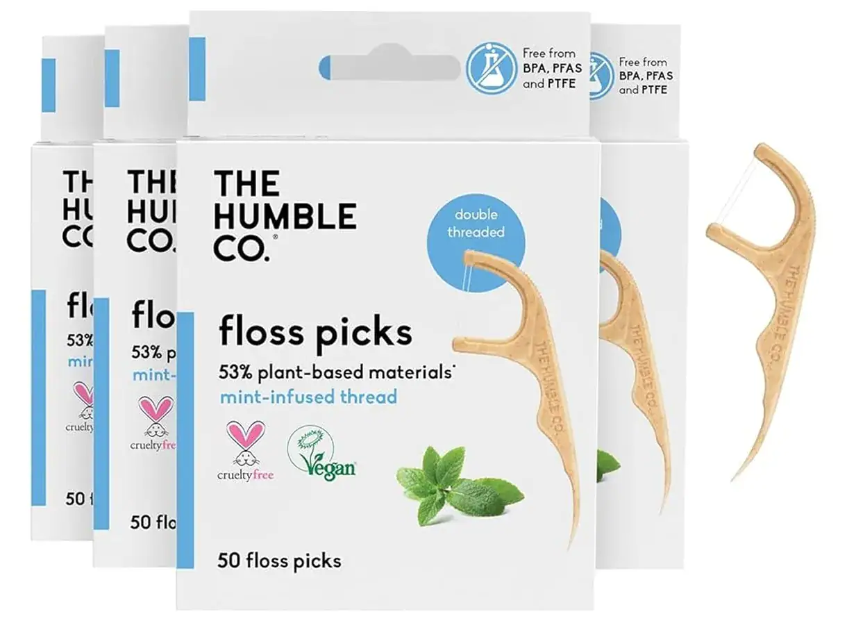 Three packs of The Humble Co. floss picks made from plant-based materials with mint flavor, cruelty-free and vegan, designed for oral hygiene.